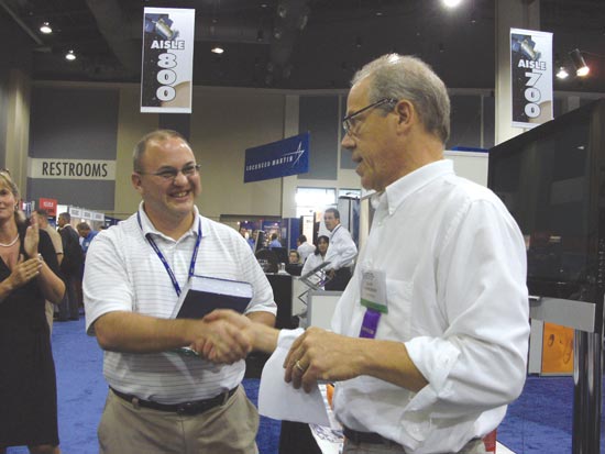 Larry Skorski of the U.S. Coast Guard took first place in GPS World’s Wii Bowling Challenge (score, 225). Editor Alan Cameron presents him with a copy of Brad Parkinson and James Spilker’s book, The Global Positioning System, signed by the first author.
