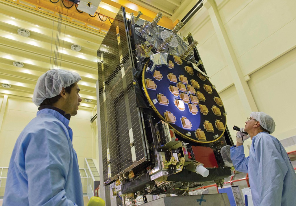 The main antenna of the second Galileo Full Operational Capability (FOC) satellite being inspected with a flashlight in advance of mass property testing at the European Space Agency’s ESTEC Test Centre in the Netherlands. Thermal-vacuum testing on the second model began in early 2014. The two FOC satellites will be launched on a Soyuz rocket from Europe’s French Guiana Spaceport in mid-2014. Whether four more can rise and begin providing initial Galileo services by the end of the year is the question of the hour.
