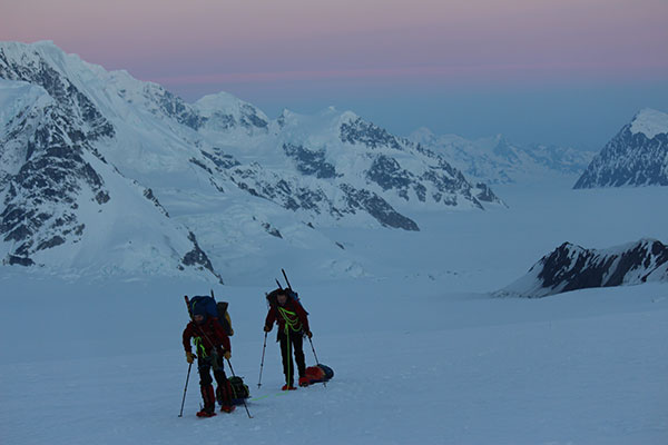 Two of the Survey climbers continue their trek up towards the next base camp, with gear in tow. Much of the climbing was done at night or early morning to take advantage of the frozen ground. (Photo: Blaine Horner, CompassData)