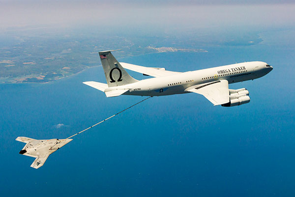 The X-47B unmanned combat aircraft receives fuel from an Omega K-707 tanker on April 22 while operating in the Atlantic Test Ranges over the Chesapeake Bay. This test marked the first time an unmanned aircraft refueled in flight. The X-47B is a tailless, jet-powered, blended-wing-body aircraft capable of semi-autonomous operation and aerial refueling.