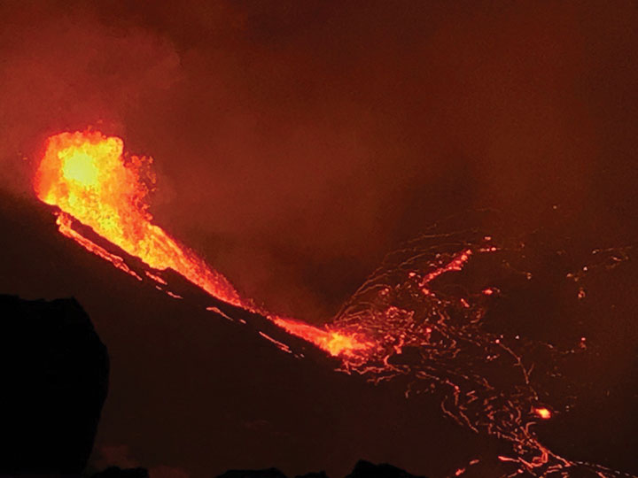 The water lake at the base of Halema‘uma‘u crater has been replaced with a growing lava lake. View from the west rim of Kīlauea Caldera just before 5 a.m. HST on Dec. 21, 2020. A 59-foot fountain joins two other fissures to feed a growing lava lake at the base of Halema‘uma‘u crater. (Photo: USGS)