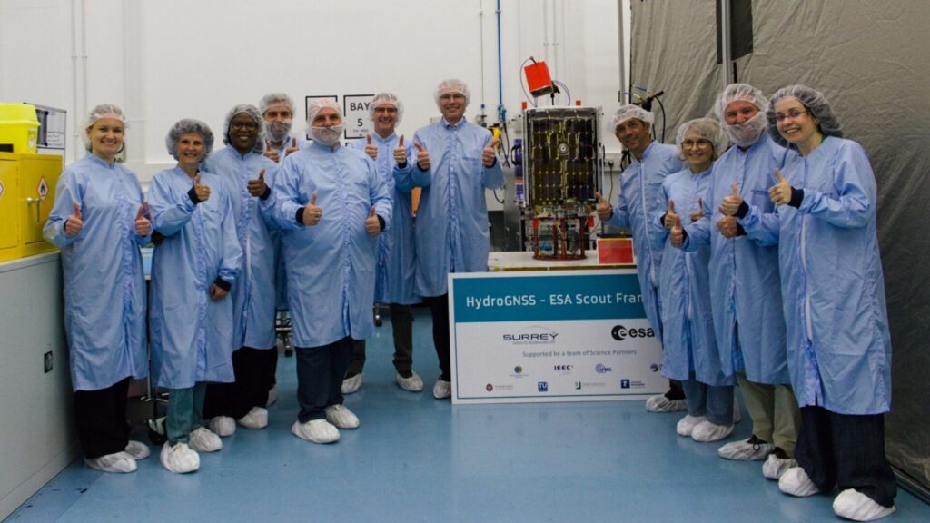 ESA’s HydroGNSS team with one of the mission's satellites.(Photo: ESA)
