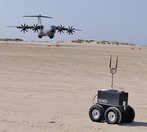 Figure 1 The autonomous UGV (BENSI) during a mission at a tactical landing zone with the A400M Atlas in the background.