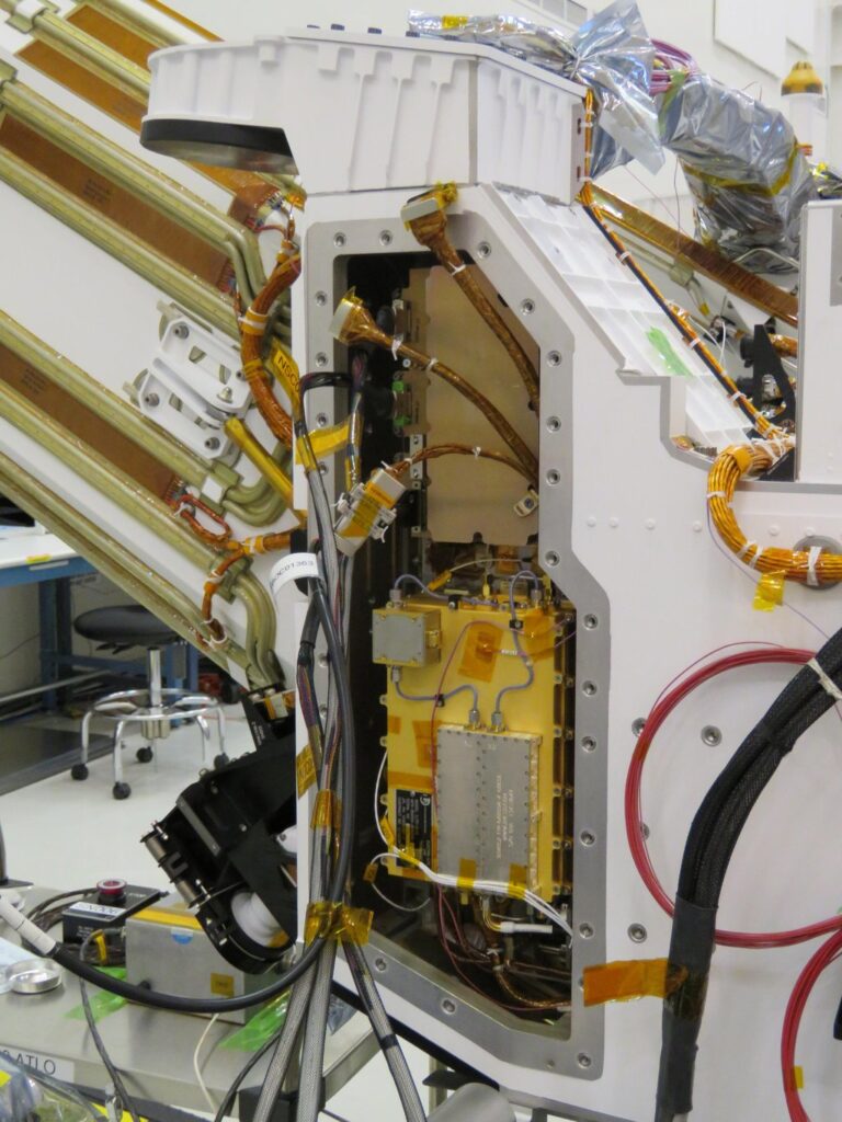 The Mars Global Localization algorithm runs on a fast commercial processor in the Helicopter Base Station — the upper, gold-colored box that was integrated into NASA’s Perseverance rover in a clean room. Perseverance used the base station to communicate with the now-retired Ingenuity Mars Helicopter. (Credit: NASA/JPL-Caltech)