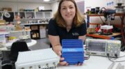 Cohda’s U.S. Sales Director Katherine Mertz with Cohda’s MK6 hardware. (Credit: Cohda Wireless)