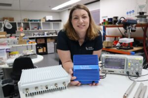 Cohda’s U.S. Sales Director Katherine Mertz with Cohda’s MK6 hardware. (Credit: Cohda Wireless)