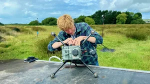 Reinhart Paelinck, CEO and founder of Kiteswarms Ltd., prepares a drone for the DroneHome field trials that took place at Wrafton, Devon, UK. (Credit: Omnisense)