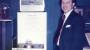 Charlie Trimble signs a gift agreement in late 1985/early 1986 to induct the Trimble 4000A GPS Locator into the collections of the Smithsonian Institution. Introduced in 1984, the 4000A was one of the first commercial GPS positioning products, heavily utilized by hydrographic survey boats. (Credit: Trimble)