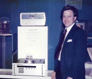 Charlie Trimble signs a gift agreement in late 1985/early 1986 to induct the Trimble 4000A GPS Locator into the collections of the Smithsonian Institution. Introduced in 1984, the 4000A was one of the first commercial GPS positioning products, heavily utilized by hydrographic survey boats. (Credit: Trimble)