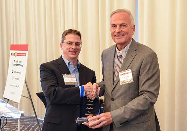 SATELLITES AWARD: Presented by Johnathan Caldwell (left) to Mark Crews, both of Lockheed Martin. Crews accepted on behalf of Tim Hartman. (Photo: GPS World)