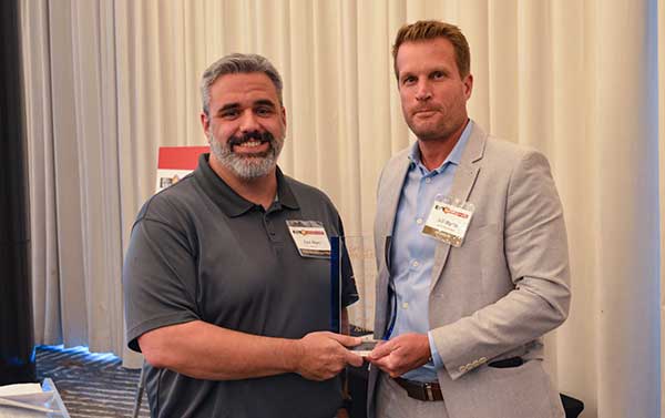 PRODUCTS AWARD: Accepted by Paul Alves (left) from presenter Jeff Martin of NovAtel. (Photo: GPS World)